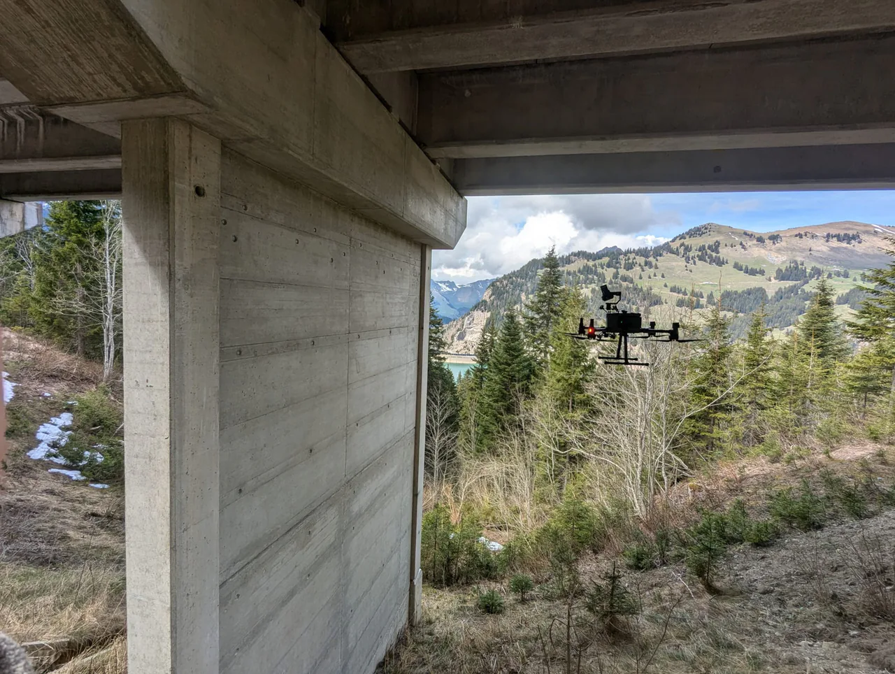 Drone image acquisition beneath a concrete bridge.